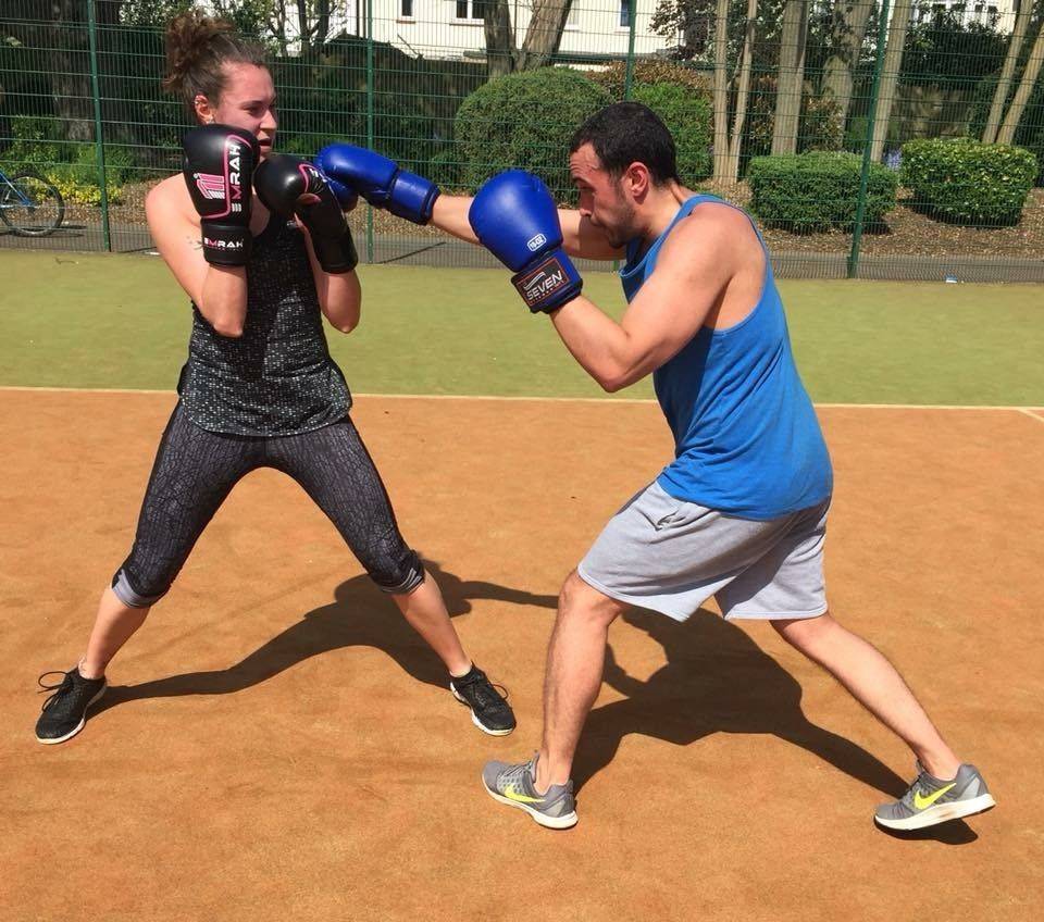 Two students sparr in the sunshine